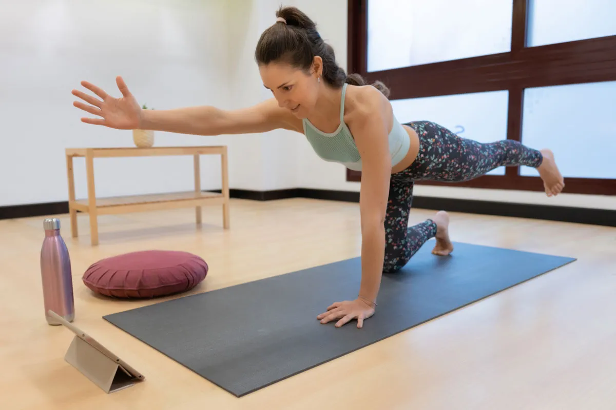 woman doing a yoga movement while looking at the t 2023 11 27 05 15 27 utc